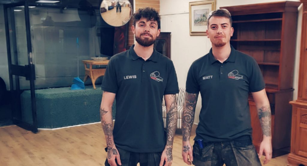 two flooring fitters standing